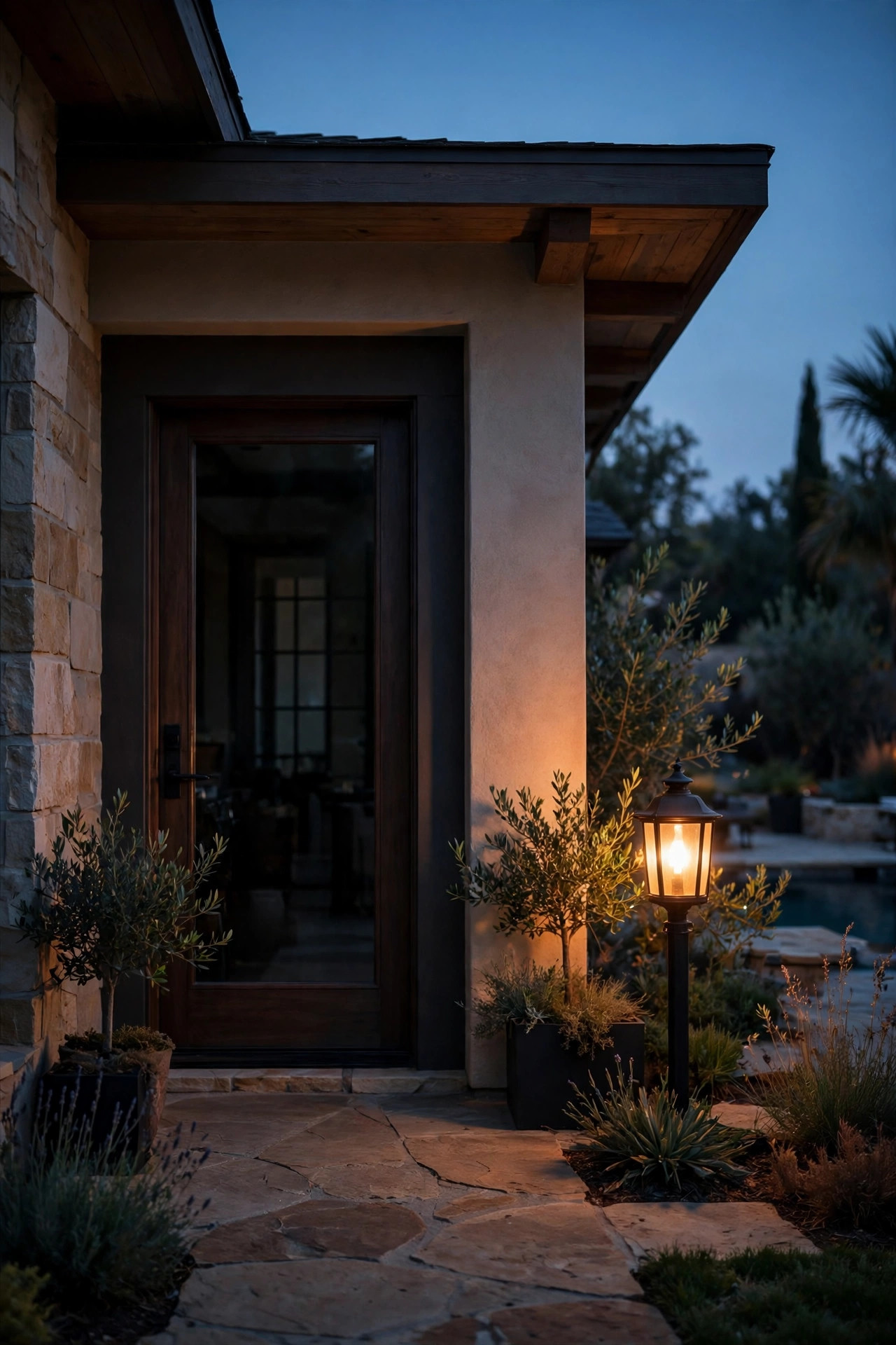 Warm amber light glowing a few feet away from a pool house door while the entrance stays softly dim